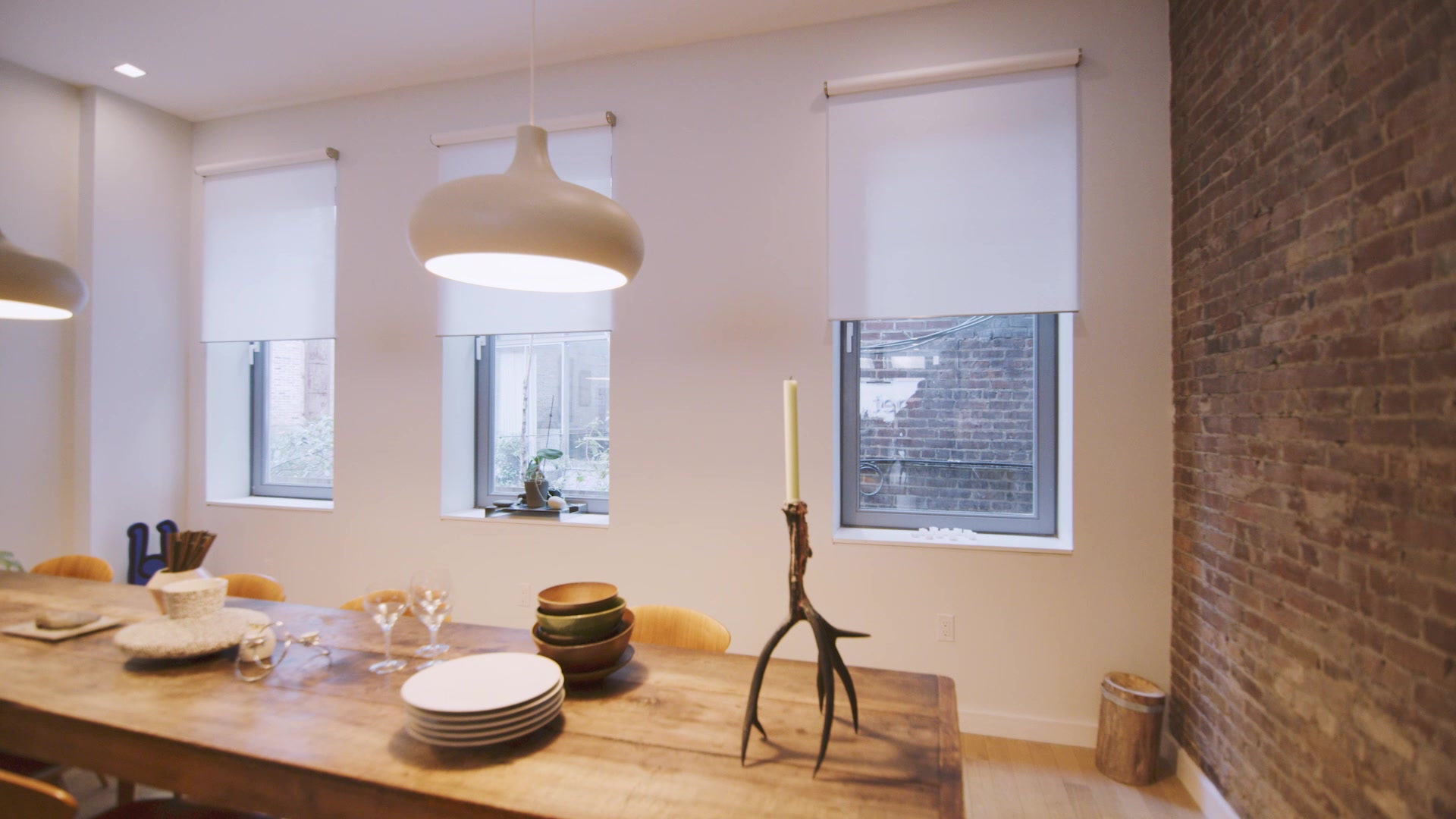 Lutron motorized roller shades in a dining room
